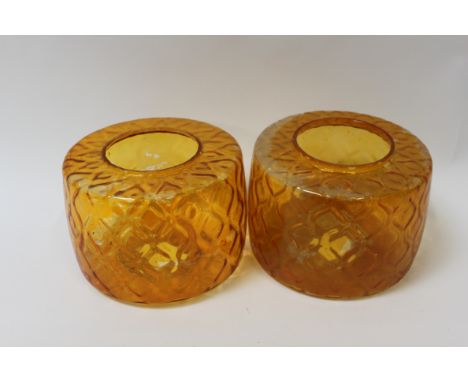 A pair of 1970's glass amber coloured lamp shades