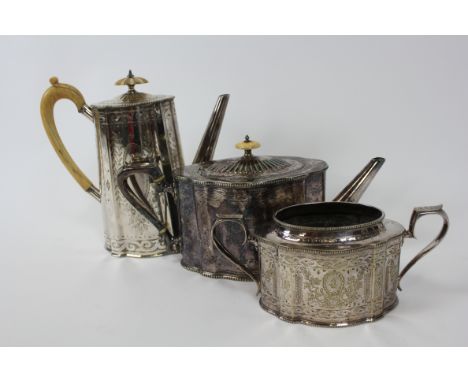 A late Victorian silver pleated tea pot, coffee pot and sugar basin, of oval canted can shape