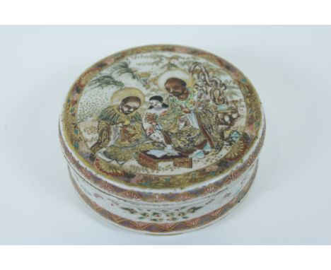 An early 20th century Japanese satsuma ceramic box and cover, decorated with two scholars and a female figure 