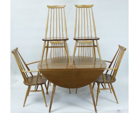 An Ercol elm and beech drop leaf table, along with four Ercol chairs and two carvers