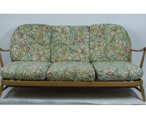 An Ercol beech and elm two seater sofa