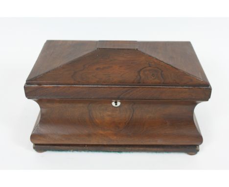 A 19th century rosewood sarcophagus shape tea caddy, with a glass mixing bowl with two fitted tea sections