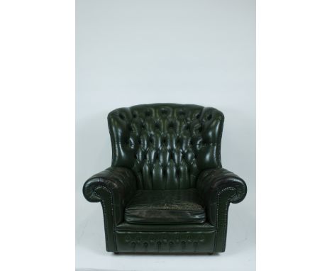 A modern leather button back armchair
