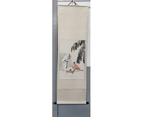A 20th century Chinese hanging scroll, painted with a scene of boy doing calligraphy