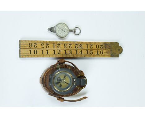 A military compass, a wooden folding ruler and a cartography gauge
