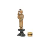 A SMALL CHINESE STAINED SOAPSTONE FIGURE TOGETHER WITH A DEER BONE ARCHER’S RING.