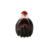 A CHINESE PURPLE GLASS 'HAND' SNUFF BOTTLE.