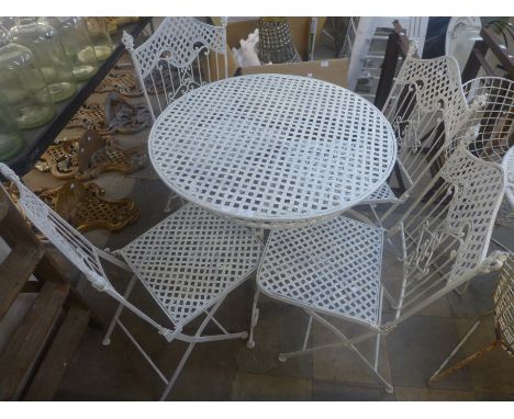 A wrought alloy garden table and four chairs 