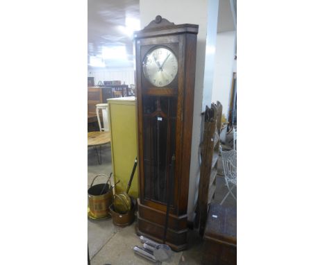 An Art Deco oak triple weight corner longcase clock 