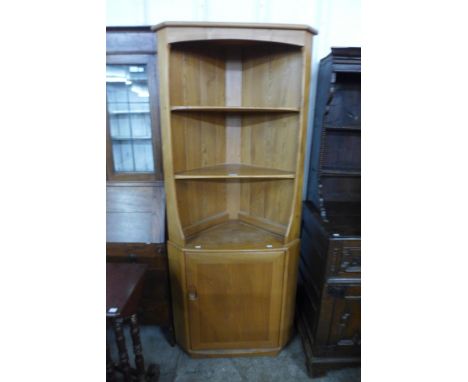 An Ercol Blonde ash corner cabinet 