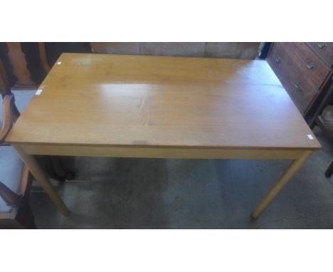 An Ercol Blonde ash and beech dining table 