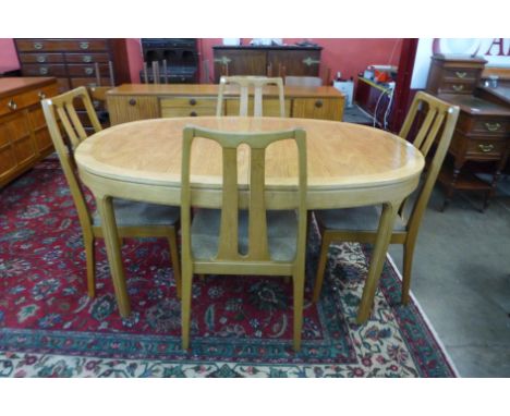 A Nathan teak extending dining table and four chairs 