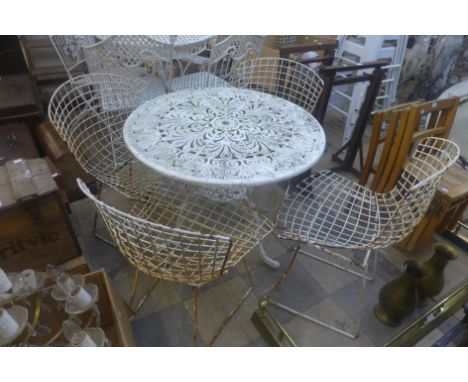 A wrought alloy garden table and four Betoia style chairs 