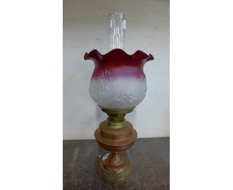 A copper oil lamp with glass shade 