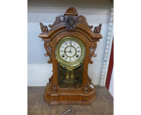 A 19th Century American Ansonia carved walnut shelf clock 