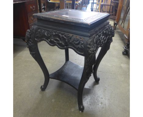 A Chinese carved ebonised softwood occasional table 