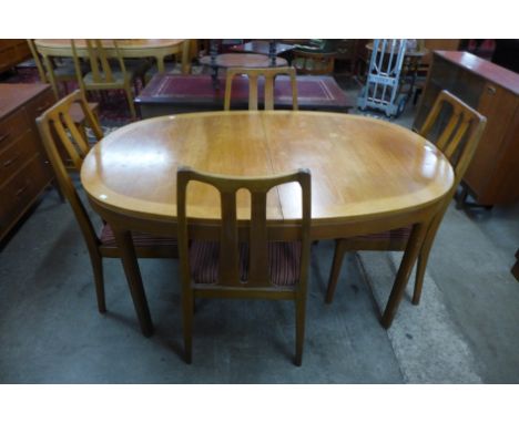 A Nathan teak extending dining table and four chairs 