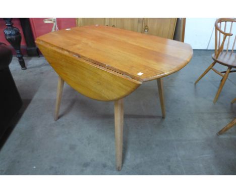 An Ercol Blonde elm and beech Windsor drop leaf table 