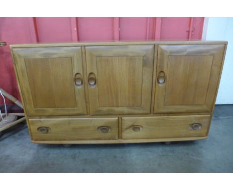 An Ercol Blonde elm and beech Windsor sideboard 