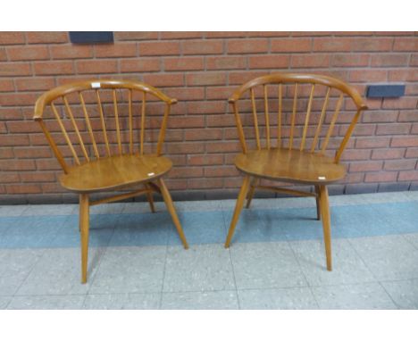 A pair of Ercol Blonde elm and beech cow horn chairs 