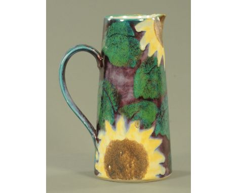 A large Dartington pottery jug designed by Janice Tchalenko, decorated with sunflowers against a purple and turquoise patch g