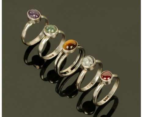 Five silver assayed dress rings, each set with semiprecious polished stones, sizes L-M.