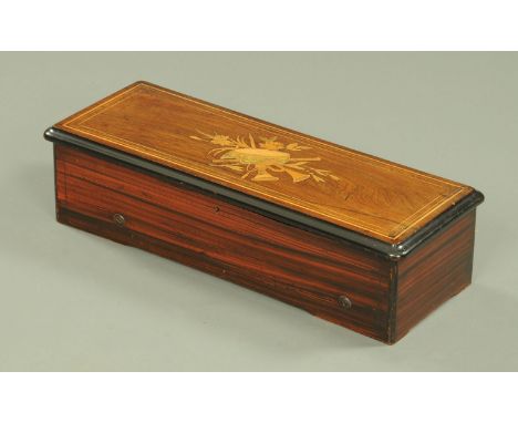 A 19th century Swiss musical box, with 13" comb, playing eight airs and with inlaid mahogany case.  Length 57 cm (see illustr