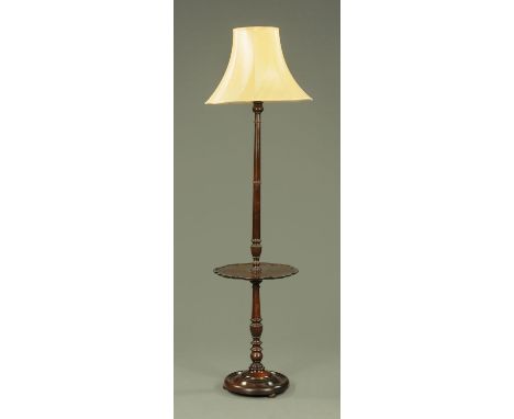 A 20th century carved and turned mahogany standard lamp, with integral silver shaped drinks shelf, all upon a turned circular