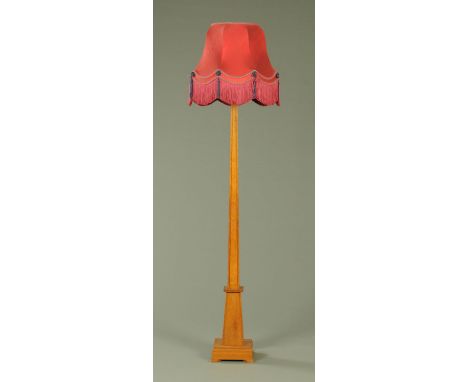 An Art Deco golden oak standard lamp, of inverted tapering square form with reeded decoration, upon a plinth base with short 