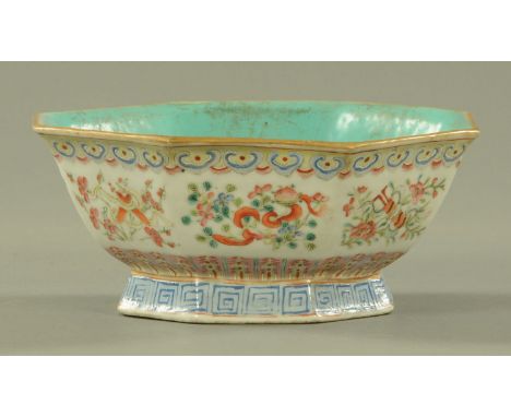 A Chinese famille rose octagonal bowl, 19th century, the interior with blue ground glaze, exterior with panels of Buddhist sy