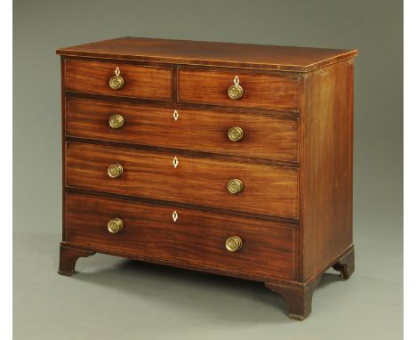 An early 19th century mahogany chest of drawers, crossbanded and boxwood and ebony strung and with two short and three long g