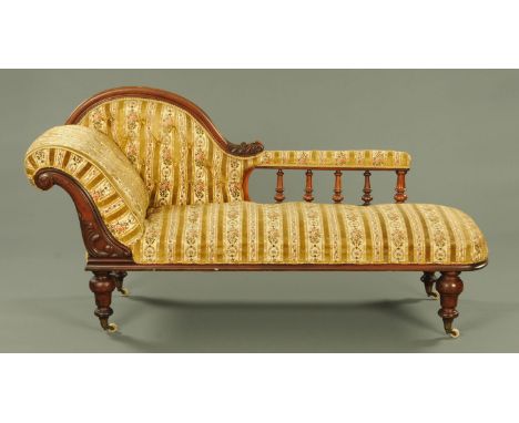 A Victorian mahogany chaise longue, with part carved show and turned showframe and upholstered in a gold floral stripe with h