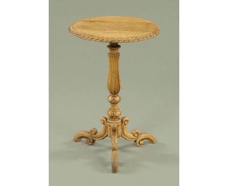 A Victorian oak tripod table, having a gadrooned border upon a carved and turned stem, all upon three "S" scroll feet.  44 cm