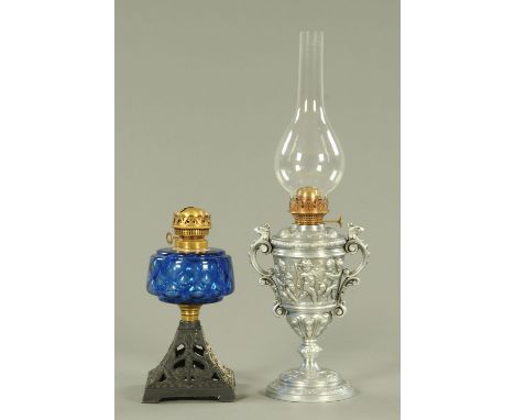 A 19th century cast metal oil lamp, decorated with cherubs with griffin scroll handles together with a Victorian oil lamp wit