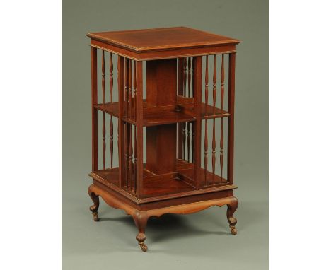 A late Victorian mahogany revolving bookcase, the square top with crossbanding and boxwood stringing above sectional tiers wi