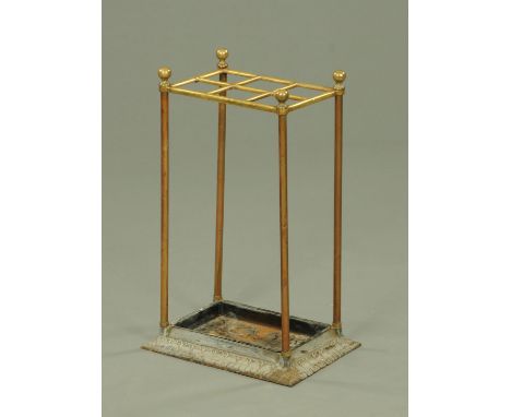 A Victorian brass stick stand, six apertures and with cast iron base.  Width 34 cm.