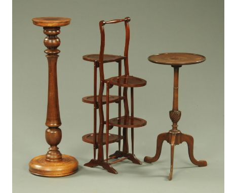 An Edwardian inlaid mahogany folding cake stand, a tripod table and plant stand.  CONDITION REPORT: The folding cake stand is