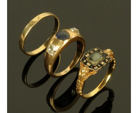 An 18 ct gold in memoriam ring, a gold coloured ring set with two diamonds and a central pale blue coloured stone and a gold 