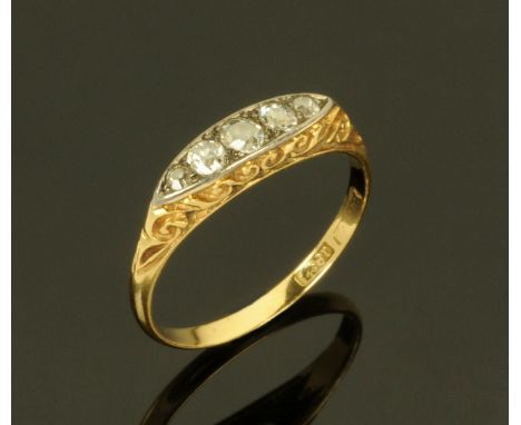 An 18 ct gold ring set with five diamonds, size M.  CONDITION REPORT: 2.1 grams. 