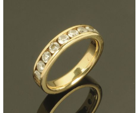 A 14 ct gold ring with 9 channel set diamonds, ring size M, 5.1 grams gross weight.