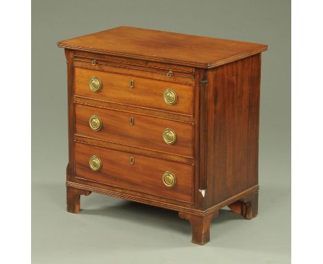 A small mahogany three drawer chest with brushing slide, the top with applied moulded edge above brushing slide and three dra