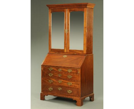 A George III mahogany bureau bookcase, the top half with moulded cornice above a pair of mirrored doors opening to shelves, d