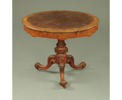 A Victorian inlaid walnut centre table, having a shaped tooled leather writing surface with carved border, the well figured i