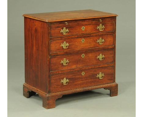 A George III mahogany chest of four drawers, the rectangular top with applied moulded edge above a brushing slide, in turn ab