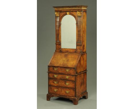A good walnut and parcel gilt Queen Anne style bureau cabinet, the top half with moulded cornice above a single mirrored door