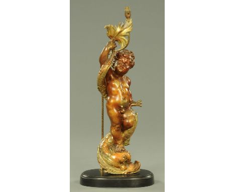 A 19th century Italian giltwood and gesso standing cherub, raised on a wooden base, with table lamp fitting.  Height excludin