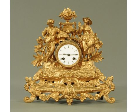 A Victorian gilded spelter mantle clock, the enamel dial with Roman numerals and eight day Japy Freres movement, chiming on a
