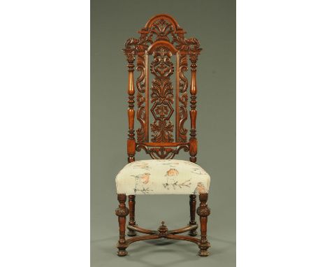 A 19th century Charles II style oak chair, having an arched pediment and foliate carved backrest between two turned supports,