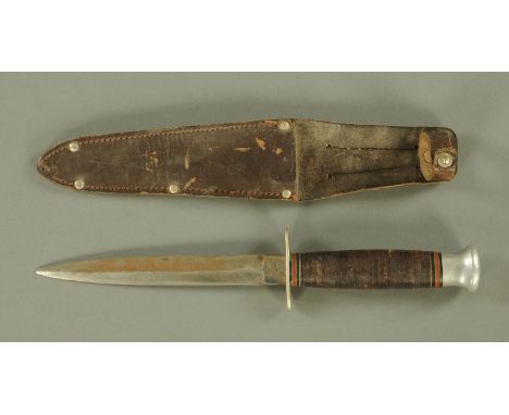 A World War Two period Fairbairn Sykes fighting knife, the blade stamped William Rodgers "I Cut my Way", with leather grip an