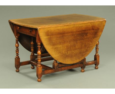 A Titchmarsh &amp; Goodwin for Barkers of Northallerton George III style oak gate legged dining table, bearing plaque to one 